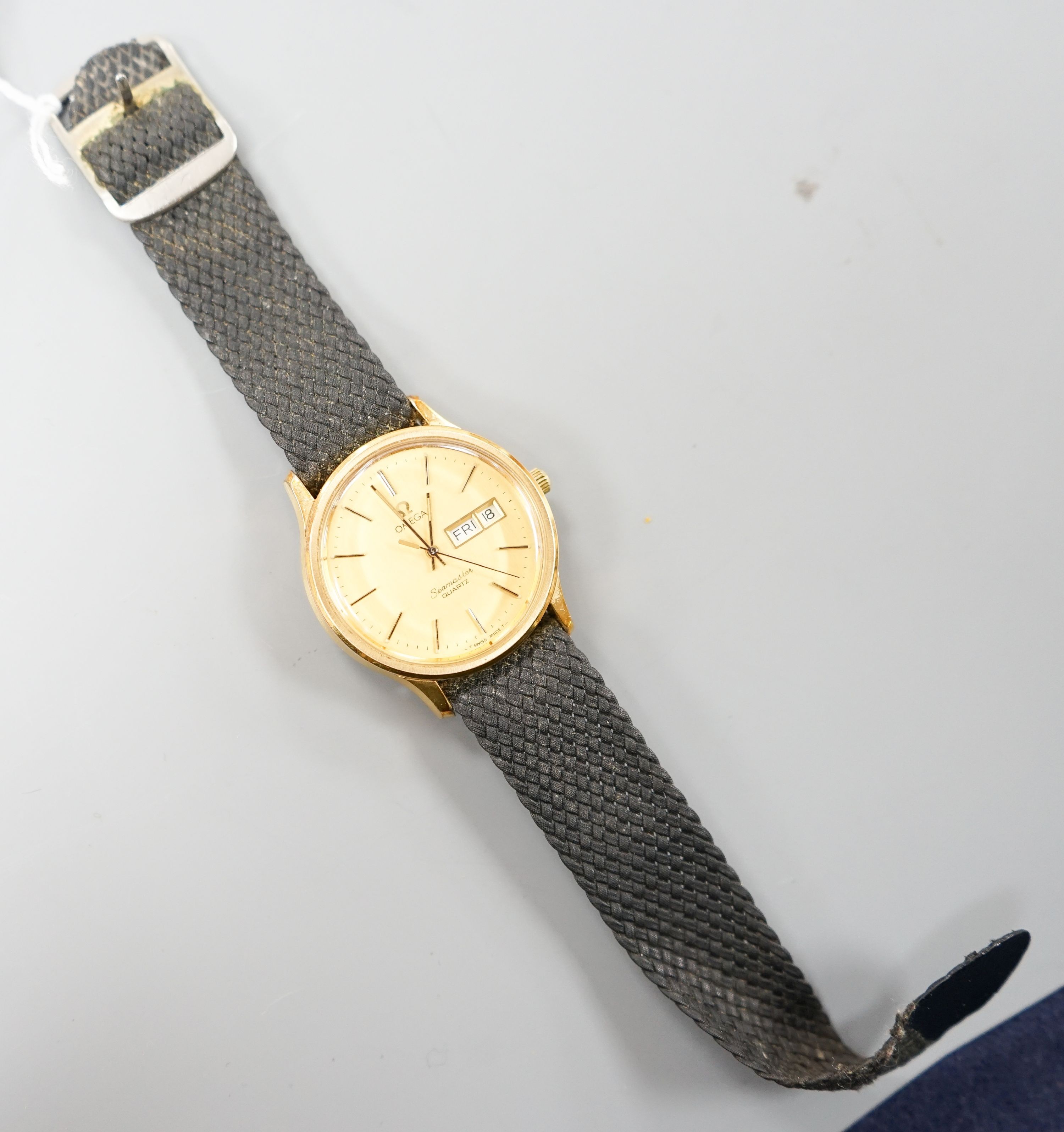 A gentleman's steel and gold plated Omega Seamaster quartz wrist watch, on associated fabric strap, no box or papers